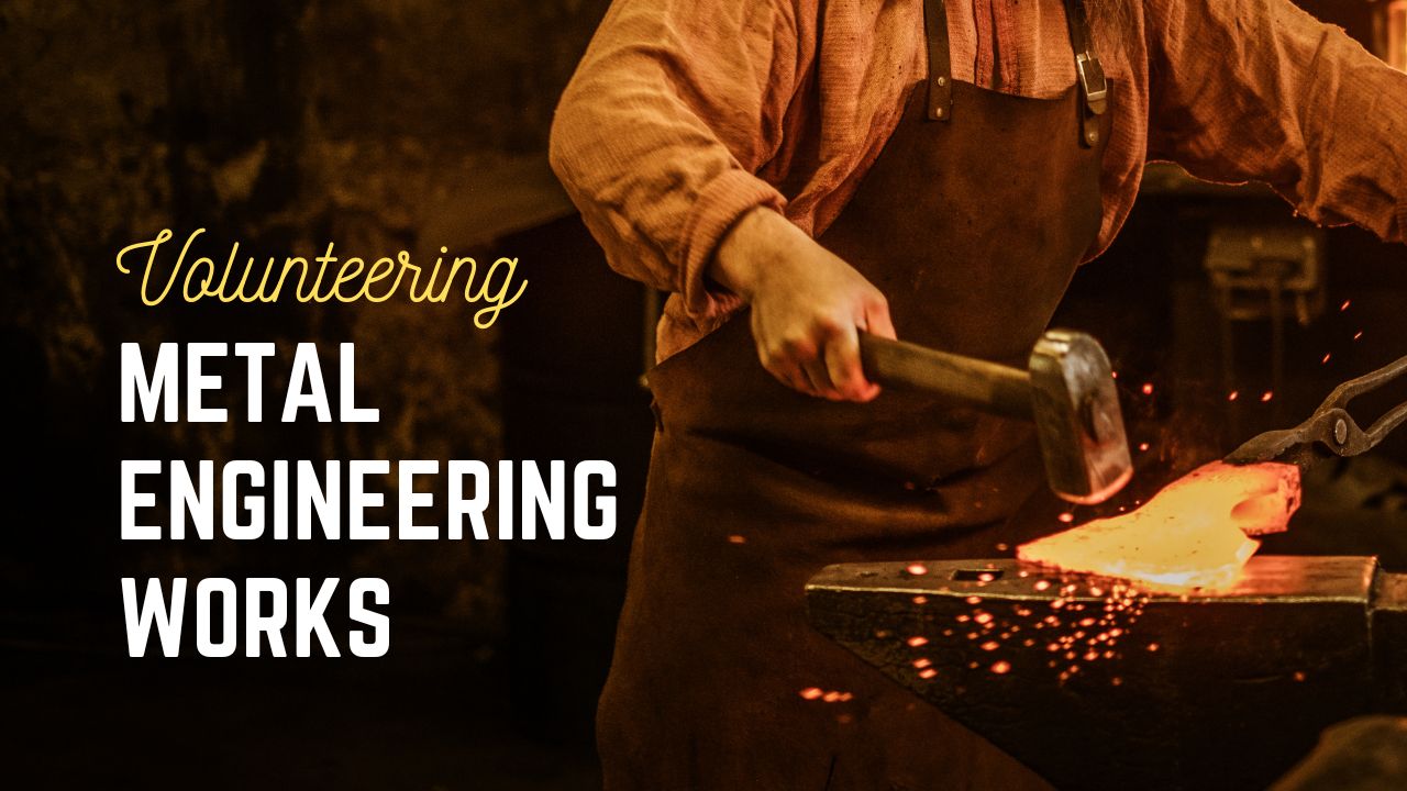 a person in an apron hammering a hot metal